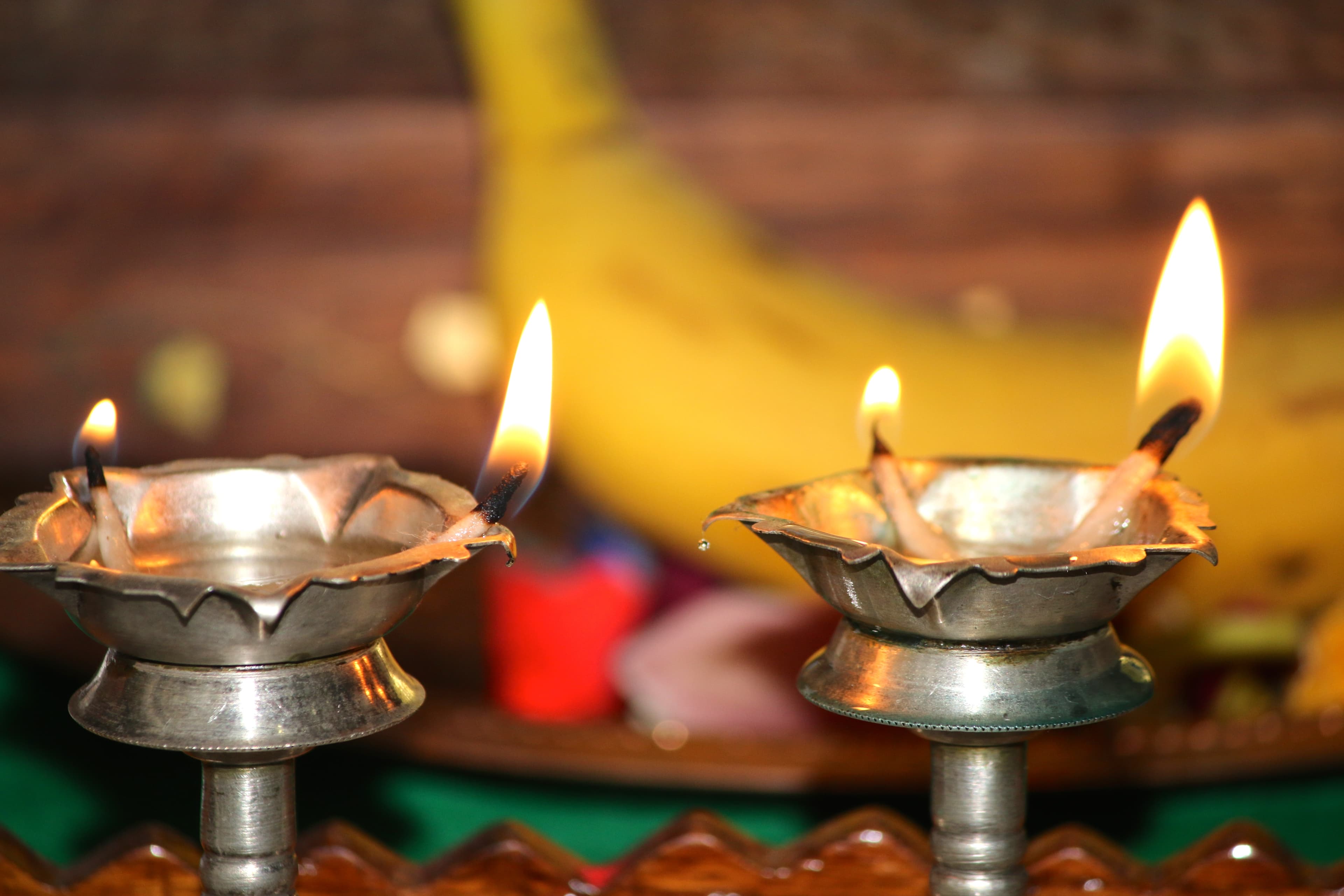 Brass oil lamps glowing during a Hindu ritual