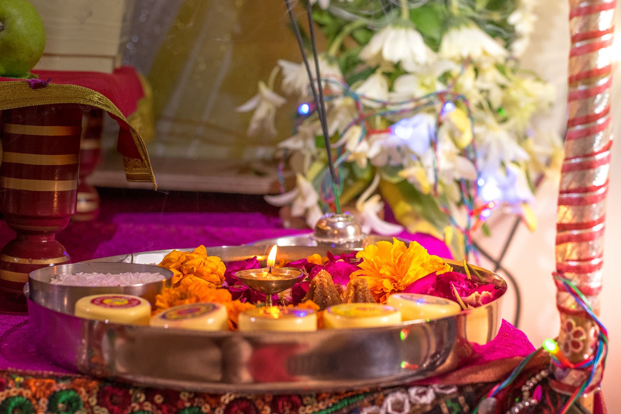 Pooja arrangement with an idol, diya and incense